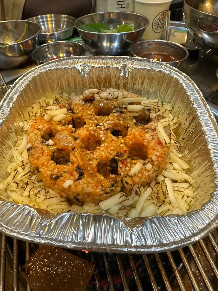 Briquette-shaped charcoal fried rice topped with cheese