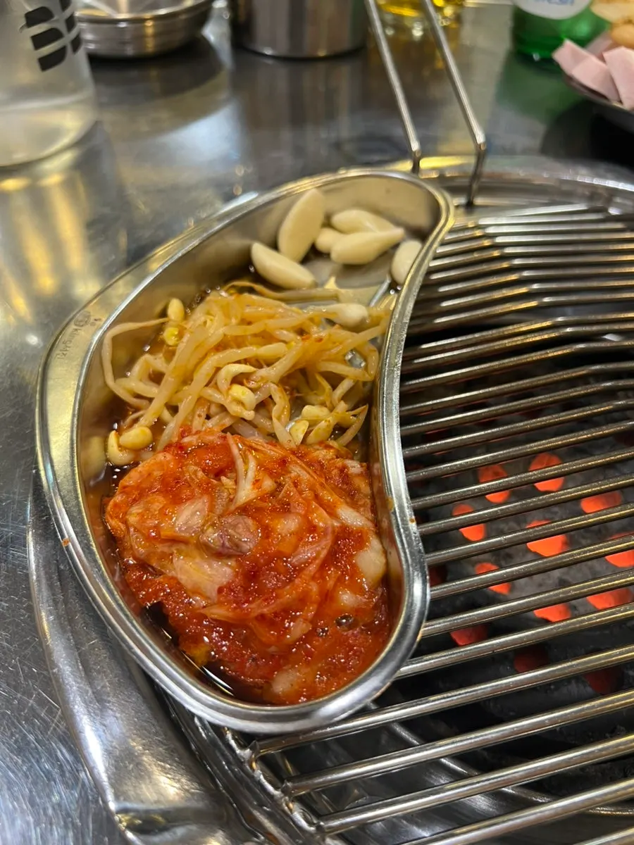 Garlic and bean sprout kimchi grilling on the charcoal