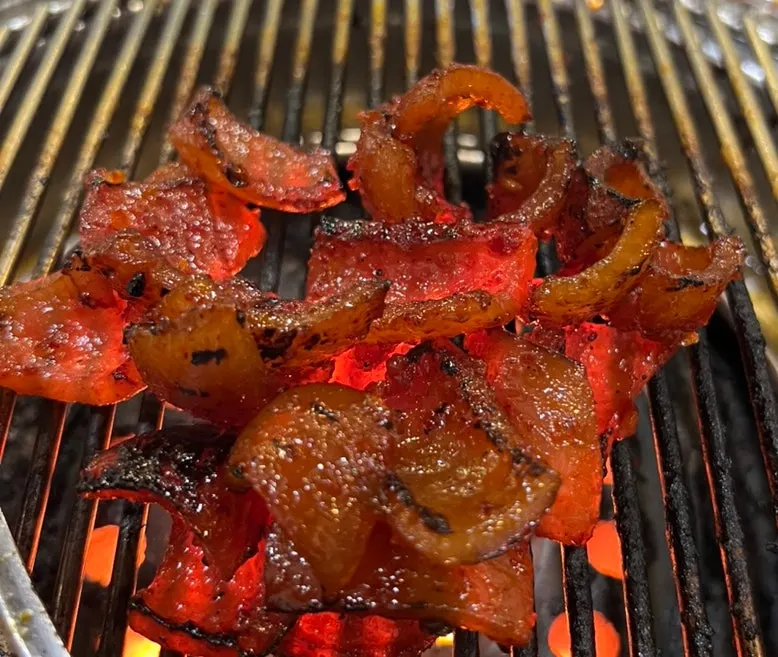 Grilled pork skin coated in leftover sauce