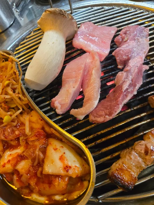 Pork jowl, skirt meat and pork back meat grilling over charcoal