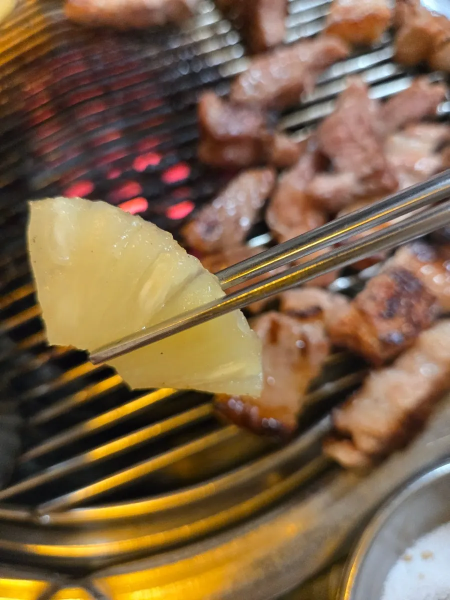 Marshmallows being grilled over charcoal