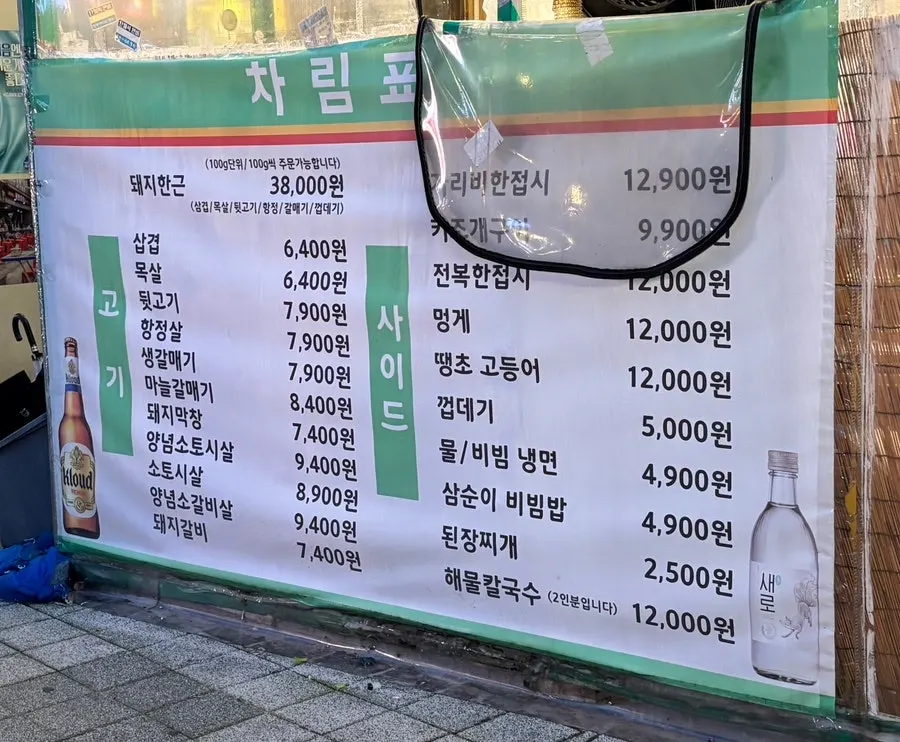 입구에서 볼 수 있는 메뉴판과 대하 소금구이 안내