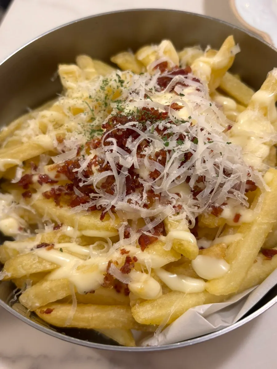 Crispy fries being dipped into sauce