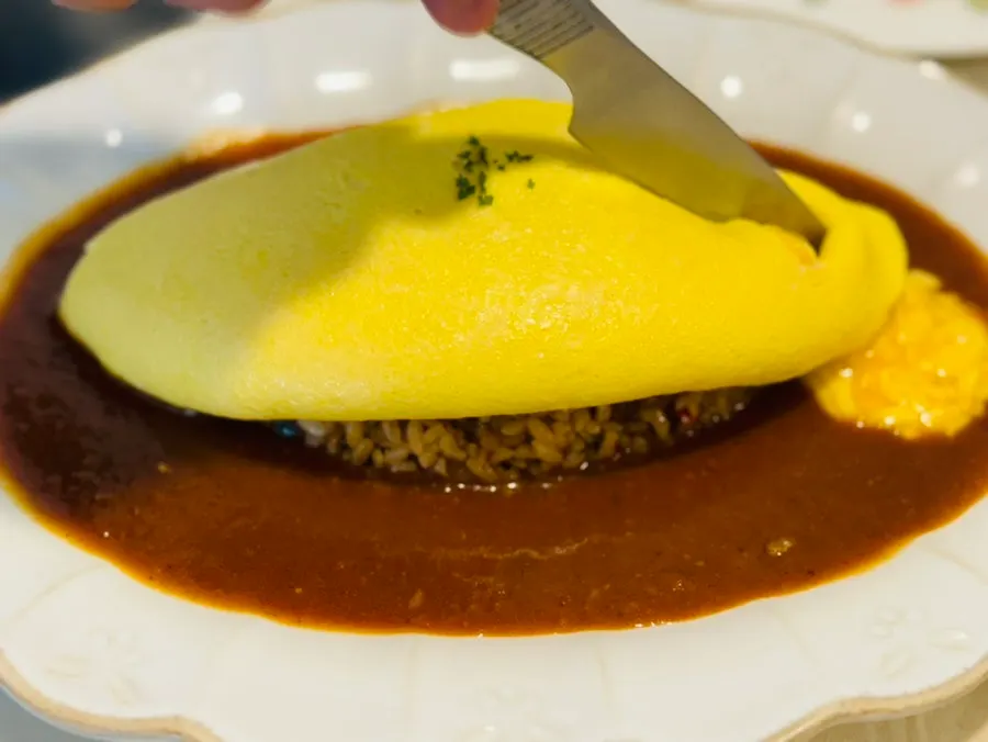 Darak omurice covered with an egg omelet