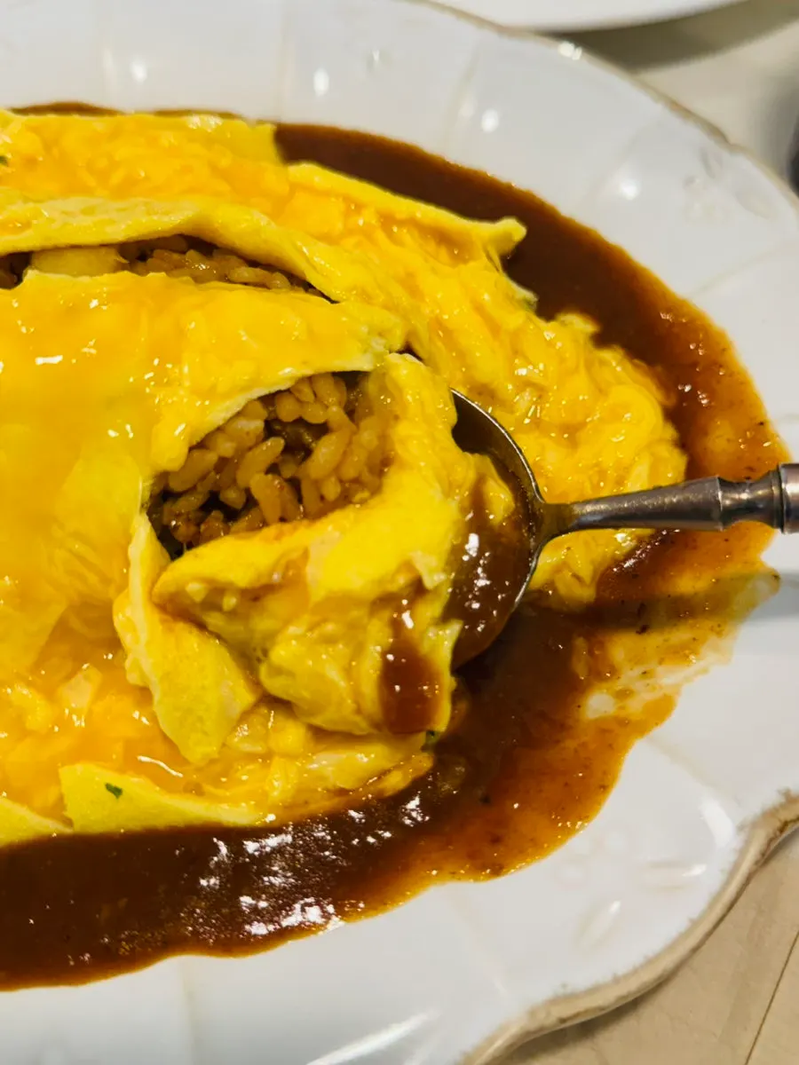 A spoonful of the loose, fluffy stir-fried omurice rice