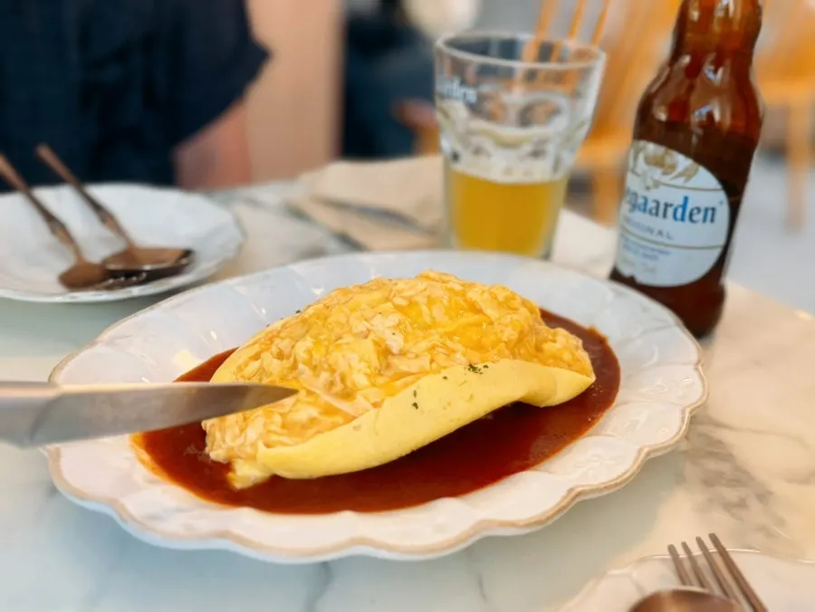 The moment the omelet is sliced open at the table