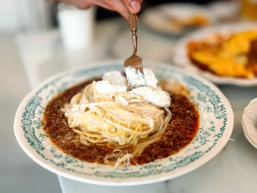 Rosé pasta noodles twirled on a fork