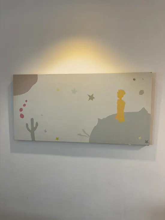 Wall decorated with Little Prince props and a mirror