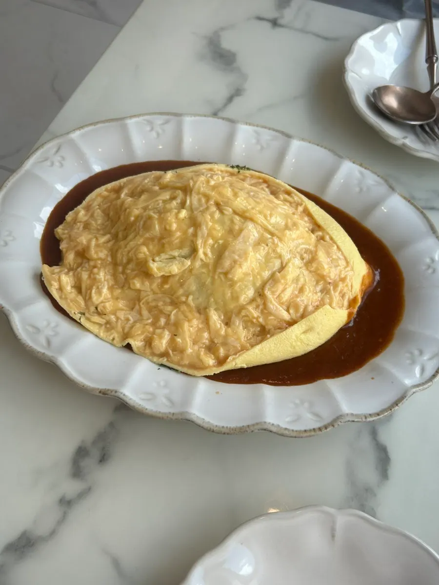Omurice egg split open by a staff member