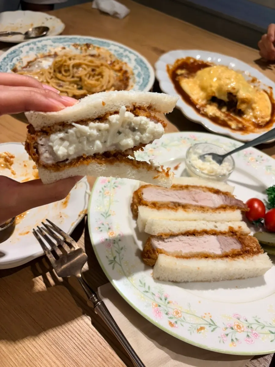 Lifting up a piece of the Katsu Sando