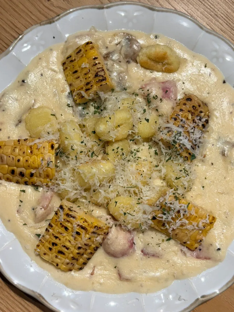 Close-up of gnocchi in corn purée cream sauce