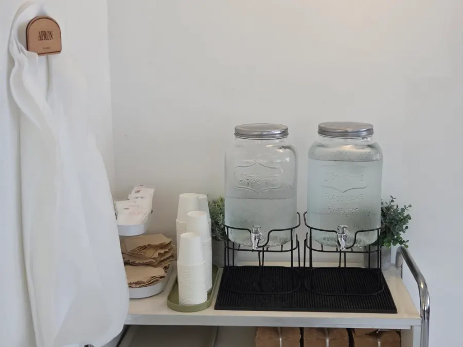 Self-service corner with water and aprons