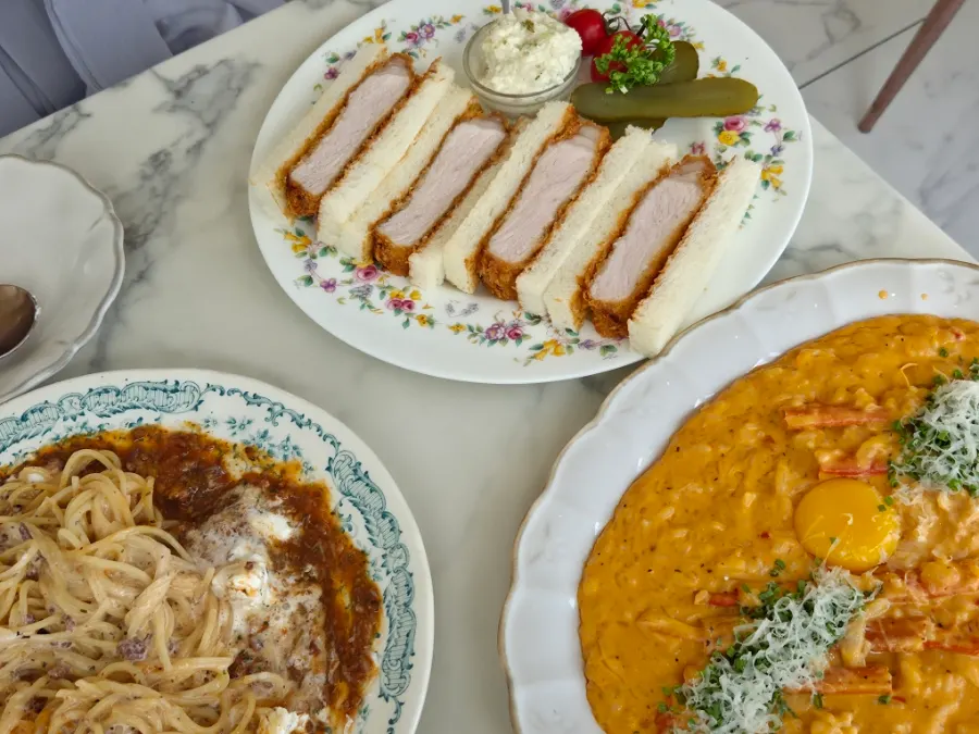 A spread of rose pasta, katsu sando, and risotto