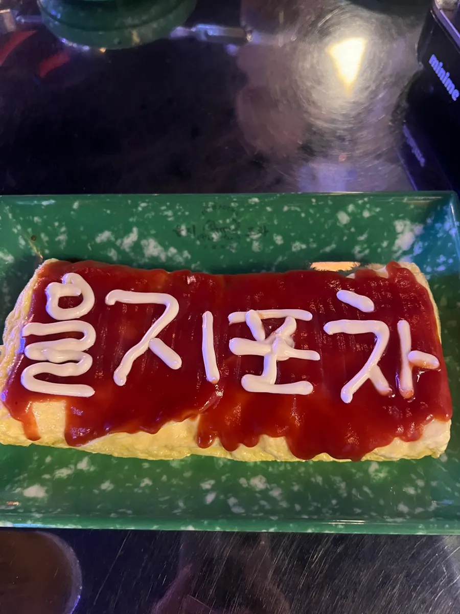 Cheese egg rolls drizzled with ketchup and mayonnaise