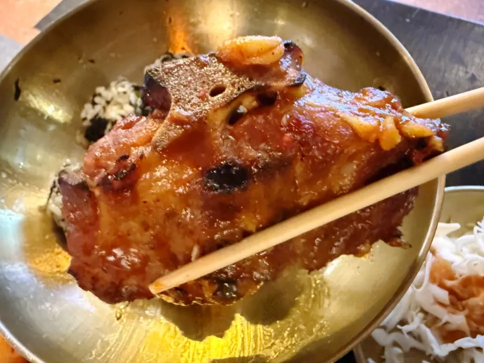 Picking the meat off the bone by hand