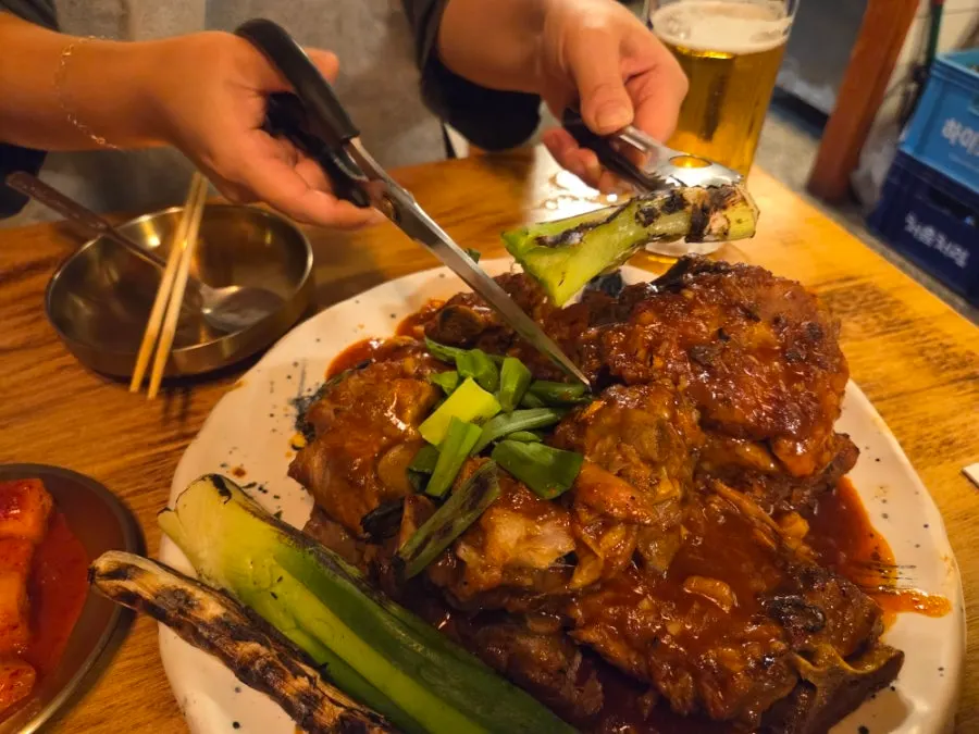 Scissors and tongs on the table meant for the scallion grill