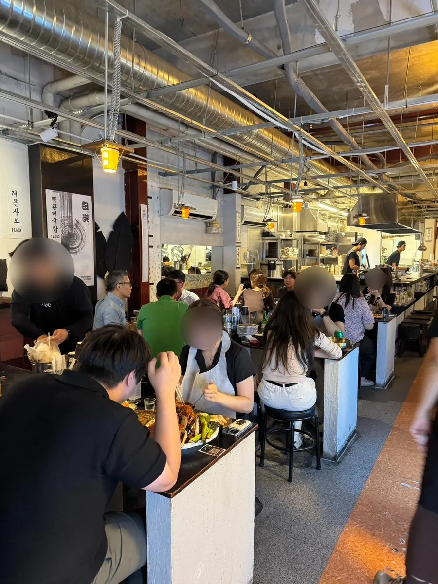 Interior with table seating and seats in front of the kitchen