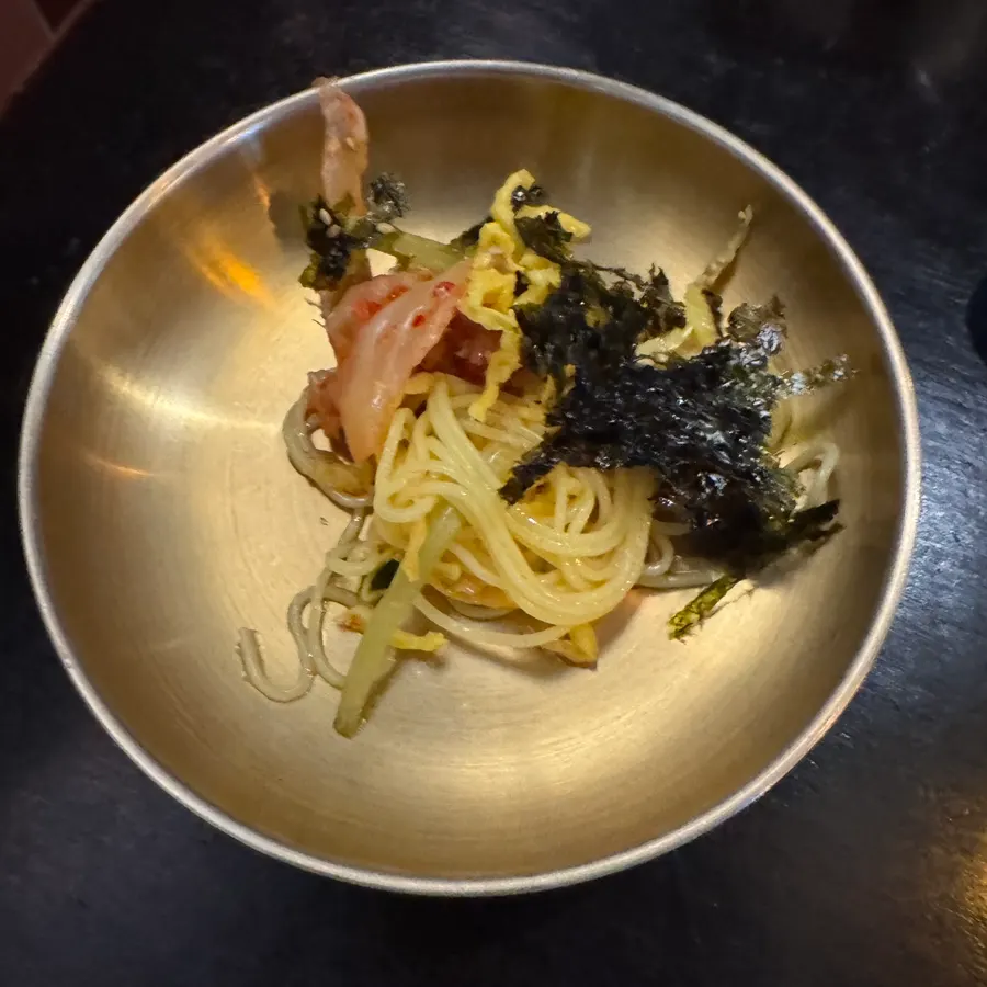 Kimchi-mari guksu served alongside spicy grilled bones