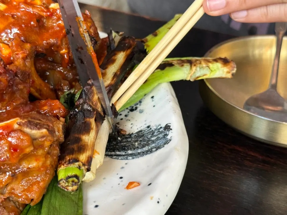 Scallions grilled alongside the bones