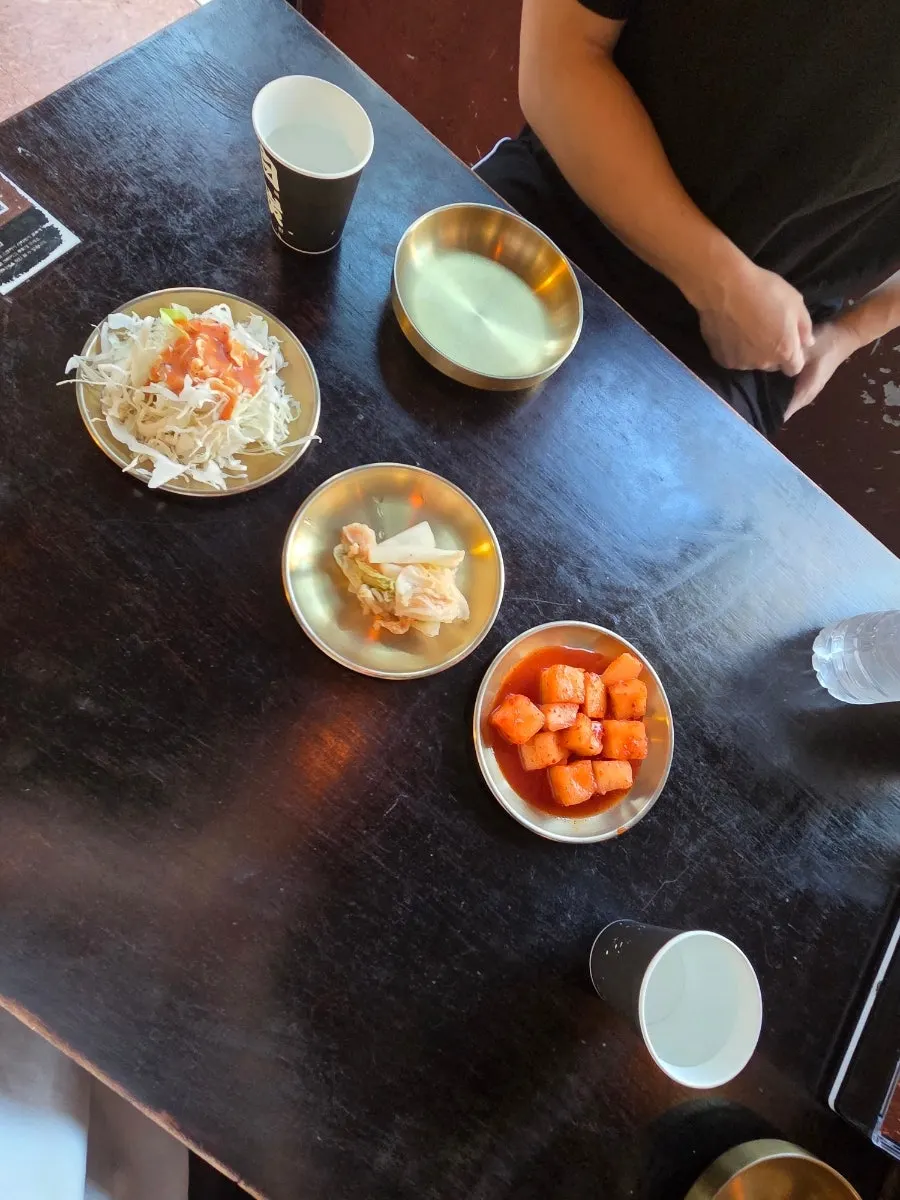 Table set with basic side dishes and a zero-sugar cider