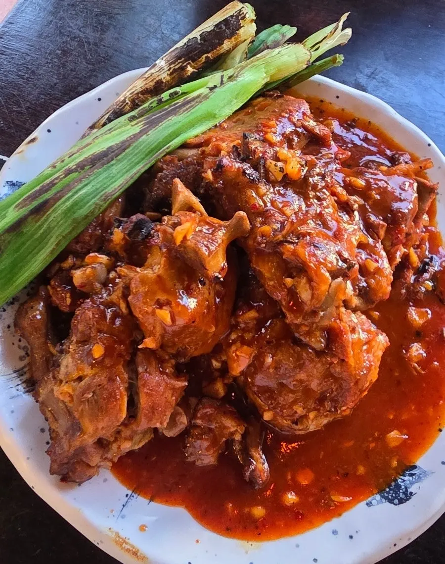 A tray of bone grill small, fully coated in sauce