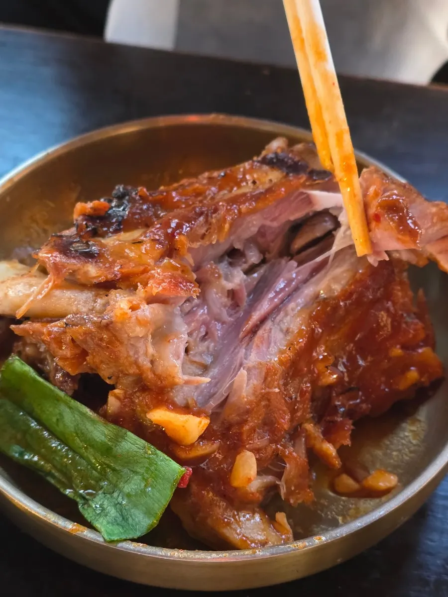 Meat picked off the bone using chopsticks