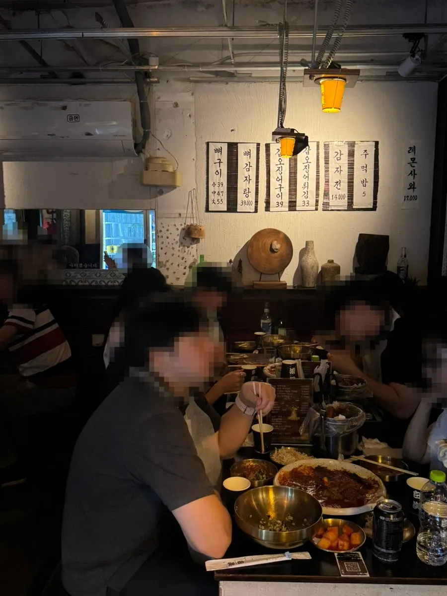 View of the dining hall with tables eating baektan grilled bones