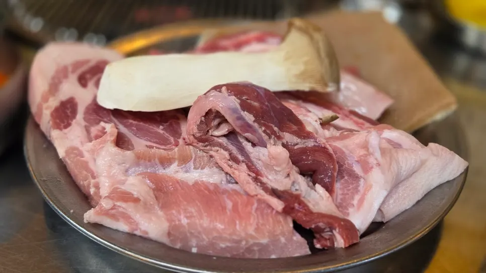 Pork placed on the charcoal grill