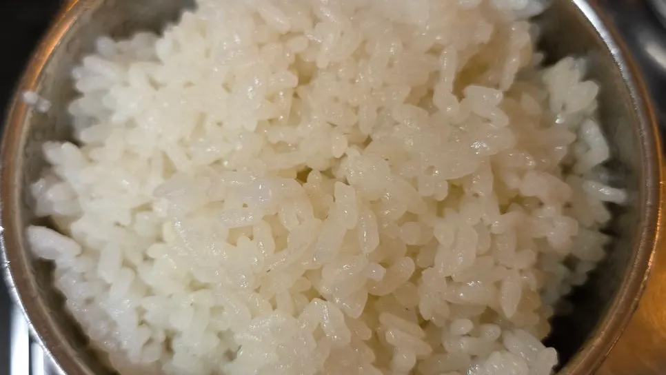 Meat spread served alongside a bowl of rice