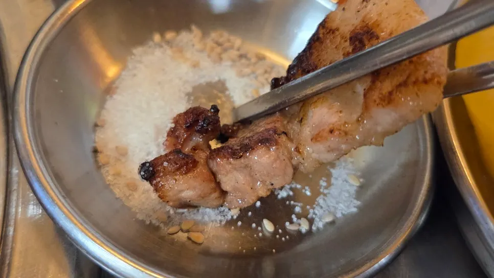 Cold noodles topped with a piece of pork belly