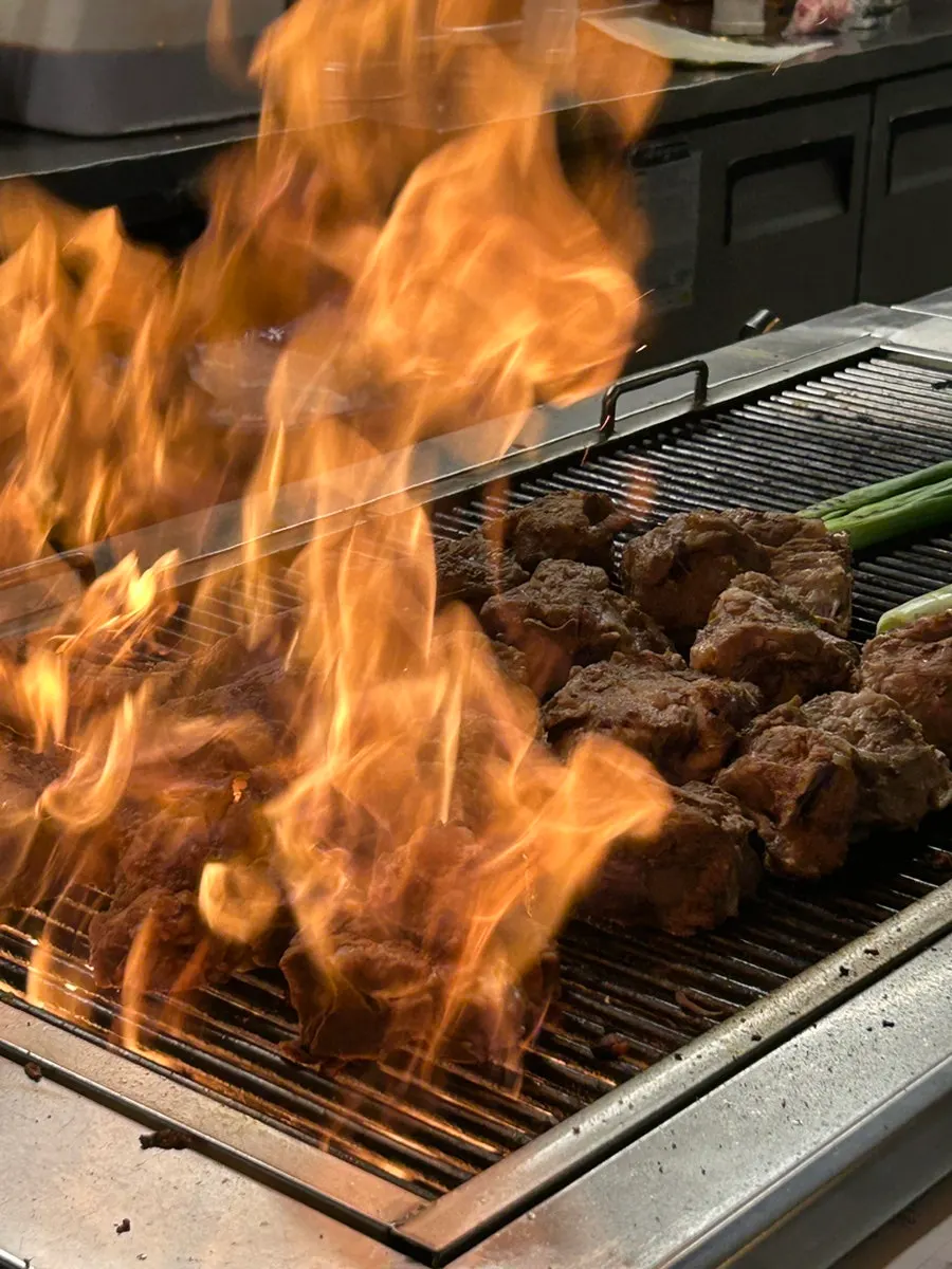 Owner grilling chadol odregi fresh at the table