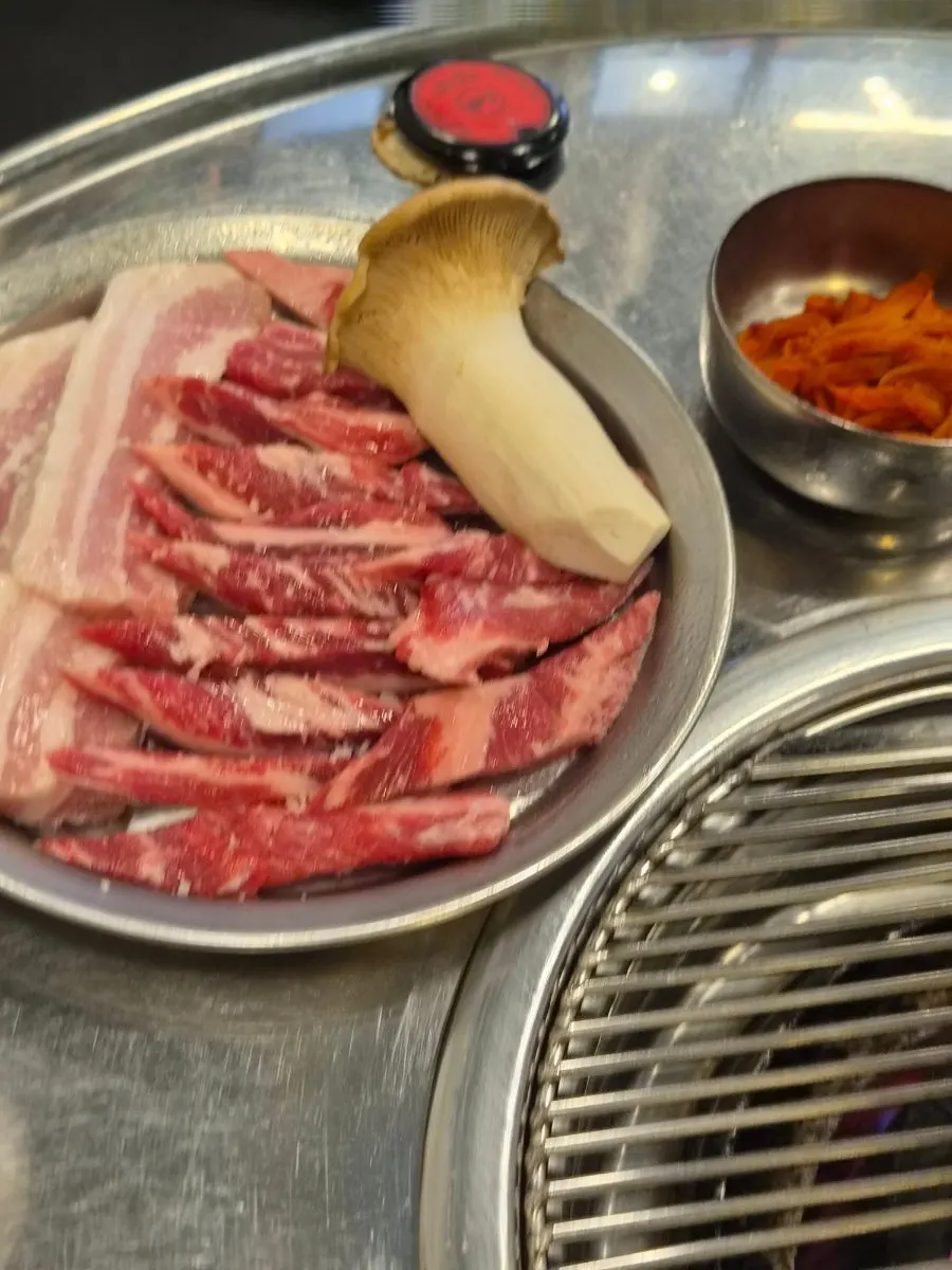 The ordered pork belly and marinated beef short rib meat set out