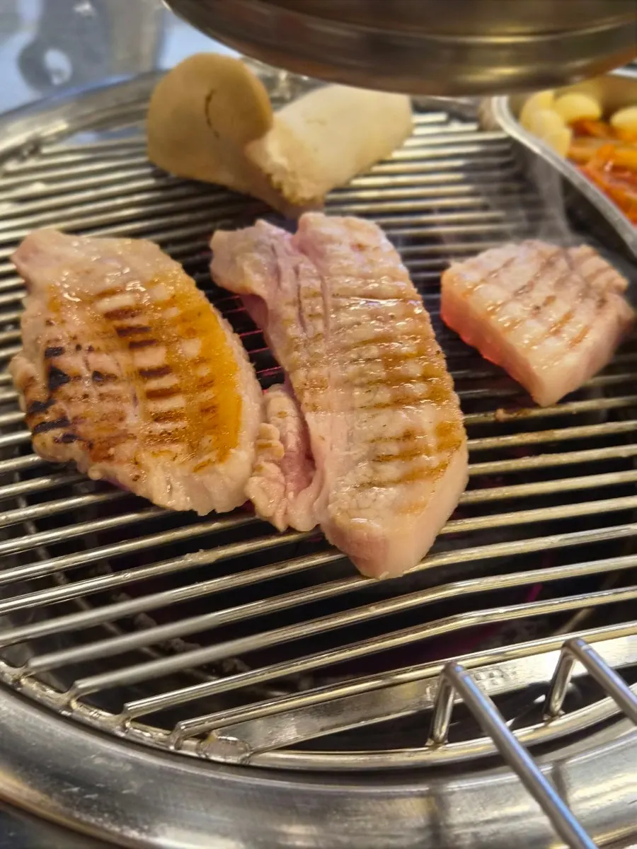 Kimchi and bean sprouts grilled on the pan with the pork belly