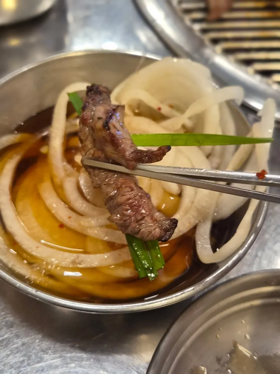 The pan with pork belly and marinated beef short rib meat grilled alternately