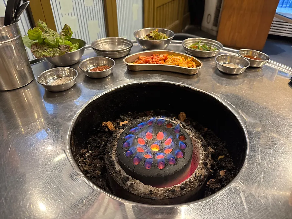 Charcoal brazier and basic side dishes on the table