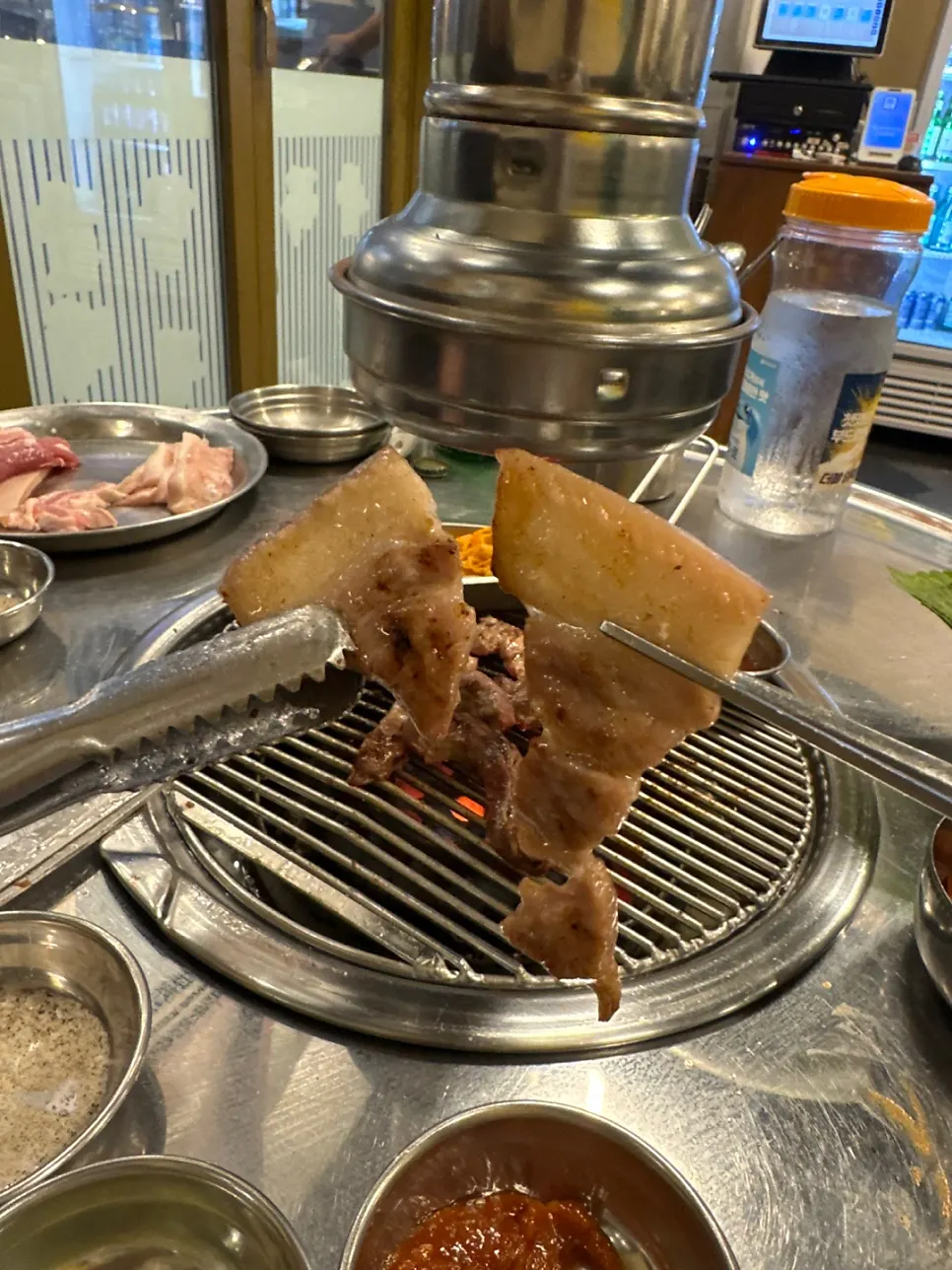 Bean sprouts and meat cooking on the grill