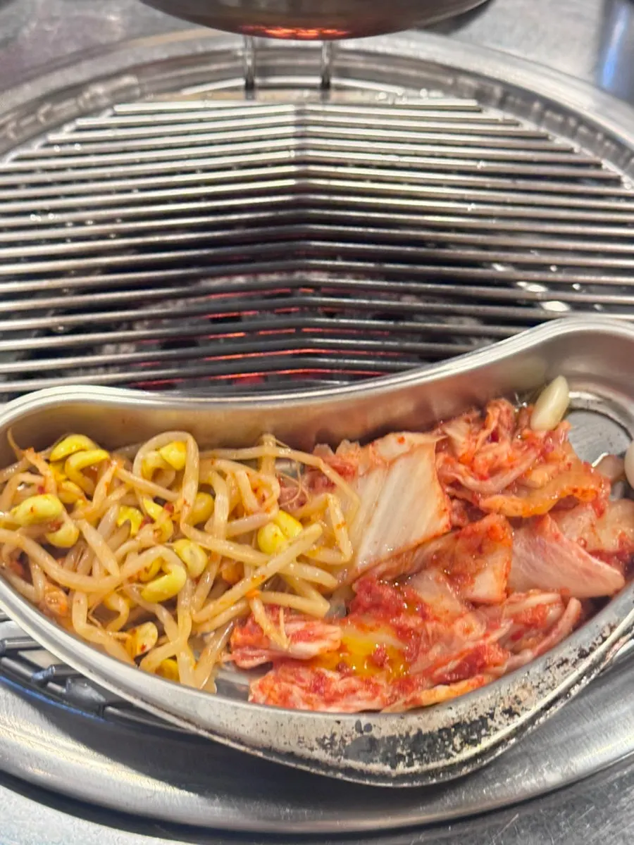 Grill plate set up over the lit charcoal