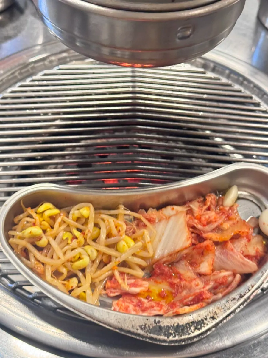 Bean sprouts and kimchi placed on the grill