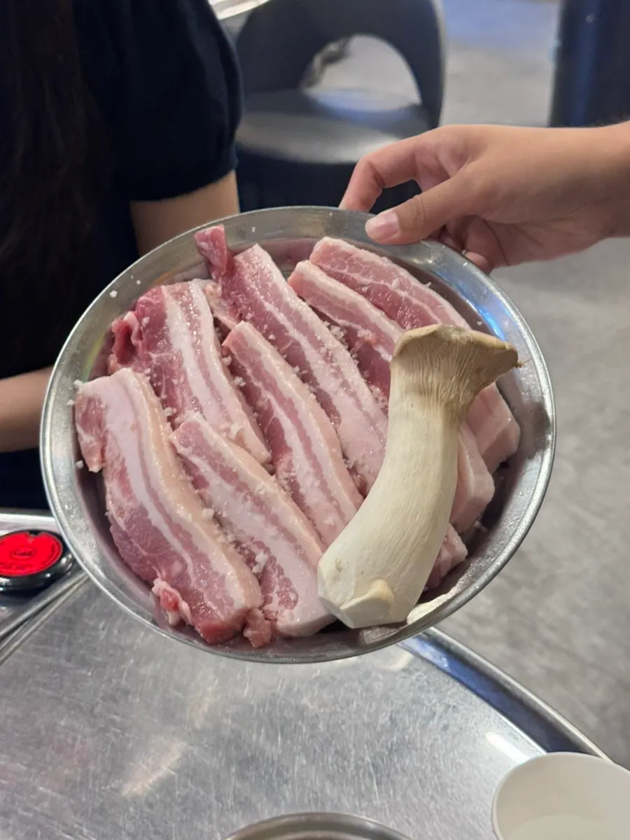 A plate of raw pork belly pre-seasoned with salt