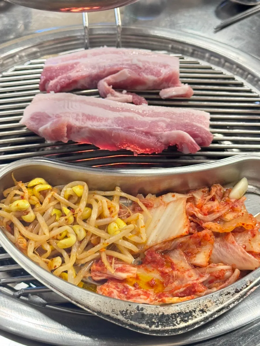 Pork belly placed on the charcoal grill plate