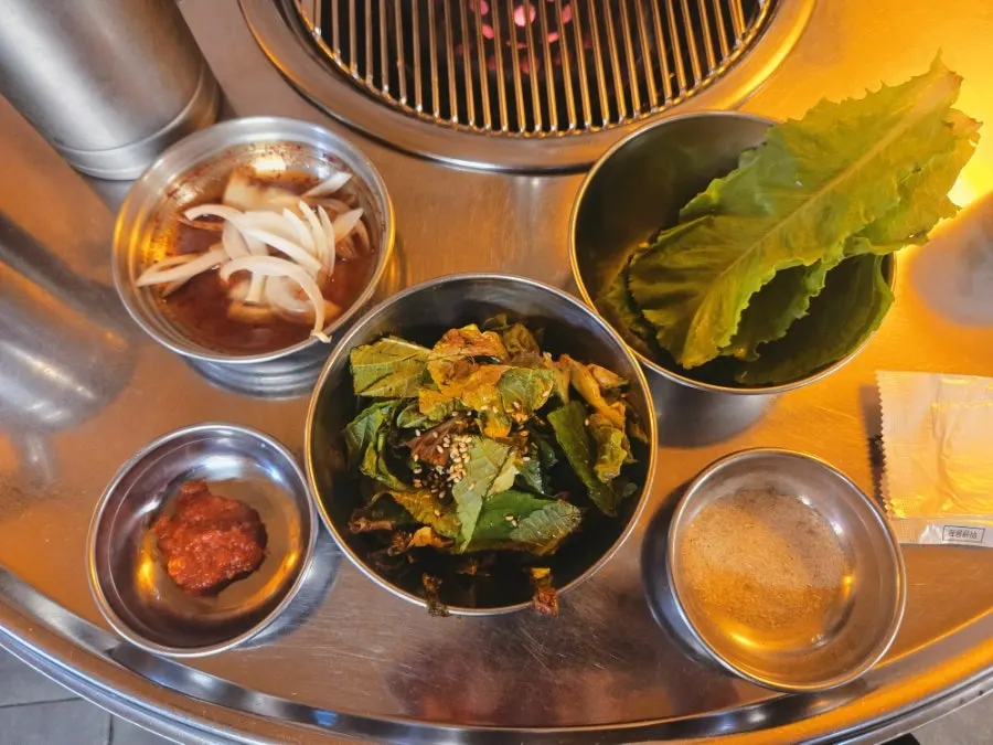 Table set with ordered meat and basic side dishes