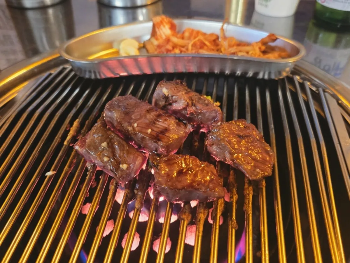 Seasoned beef flap steak on the charcoal grill
