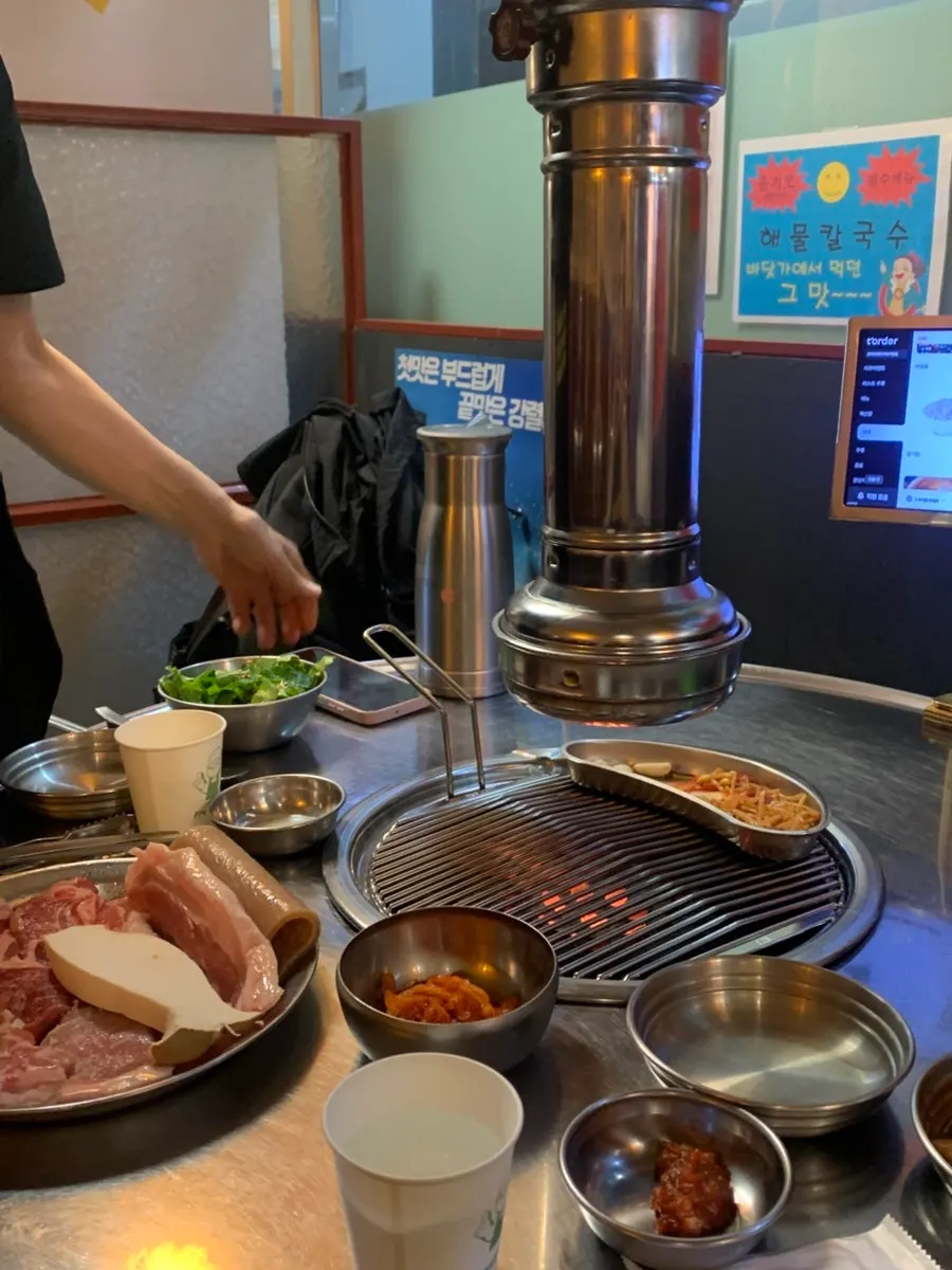 Raw meat set and grill placed on the table