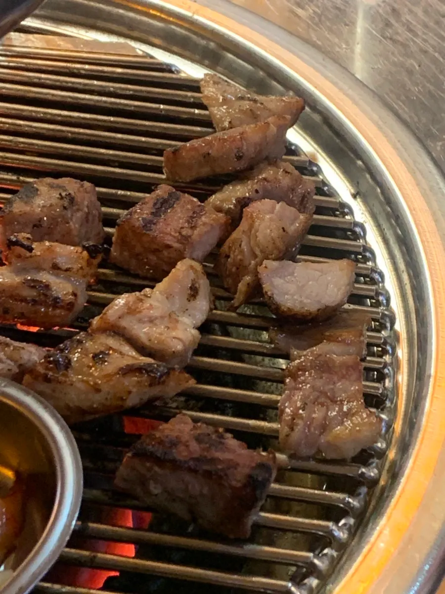 A full spread of charcoal BBQ with soybean stew