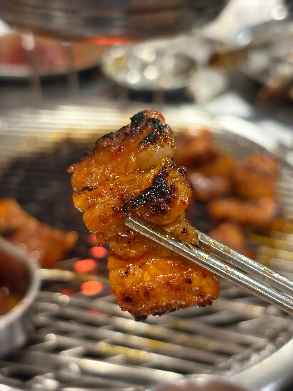 Gochujang pork belly grilling over charcoal