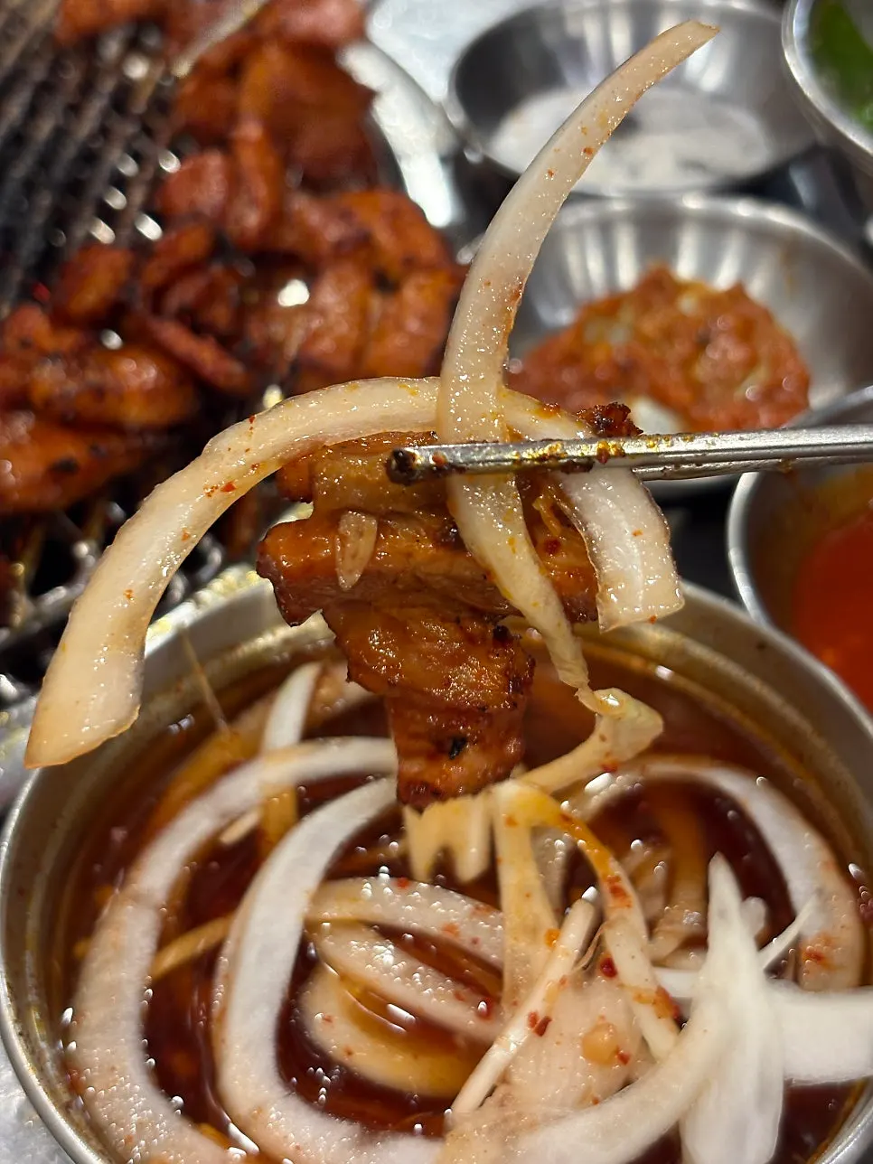 Gochujang pork belly served with onion salad