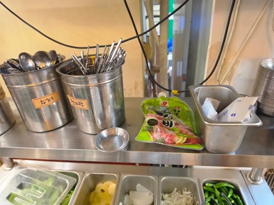 Self-serve bar with kimchi and lettuce wraps neatly arranged