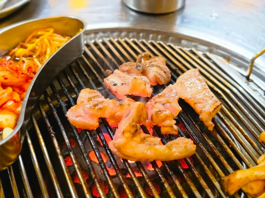 A piece of charcoal-grilled pork dipped in sauce