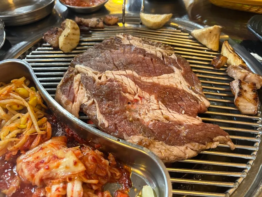 Marinated pork ribs grilling on the grate