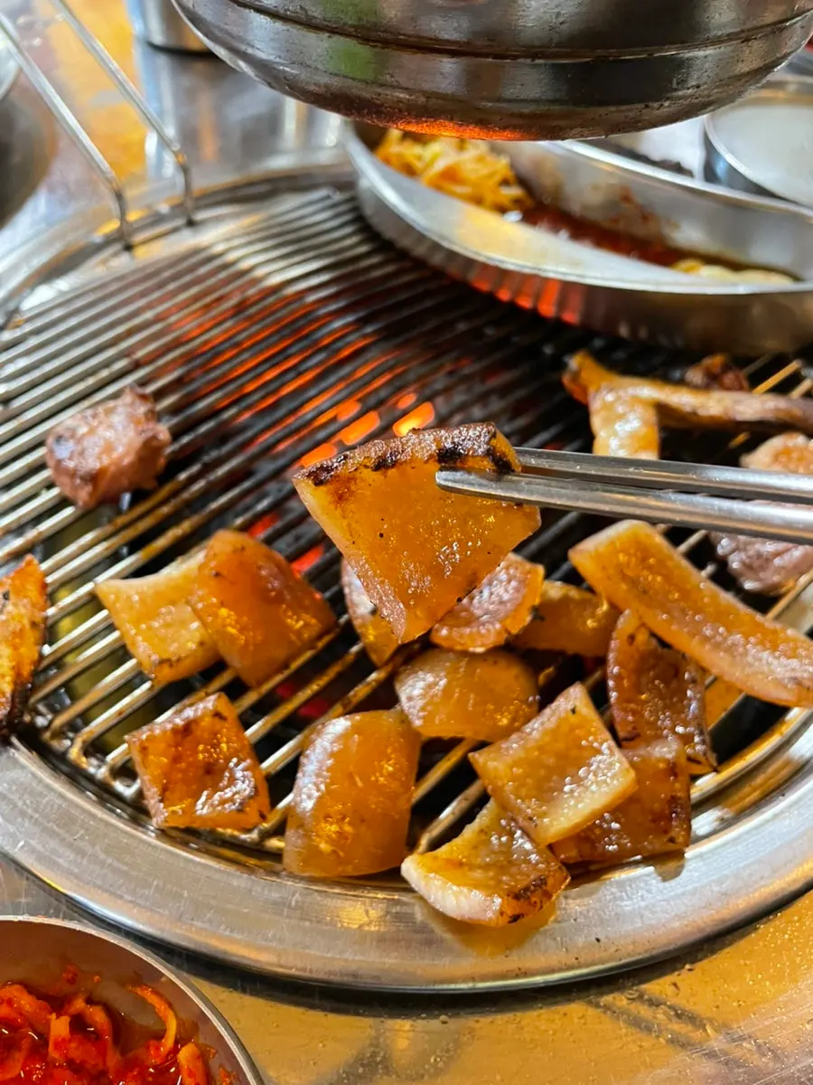 Various cuts from the pork platter grilled over charcoal